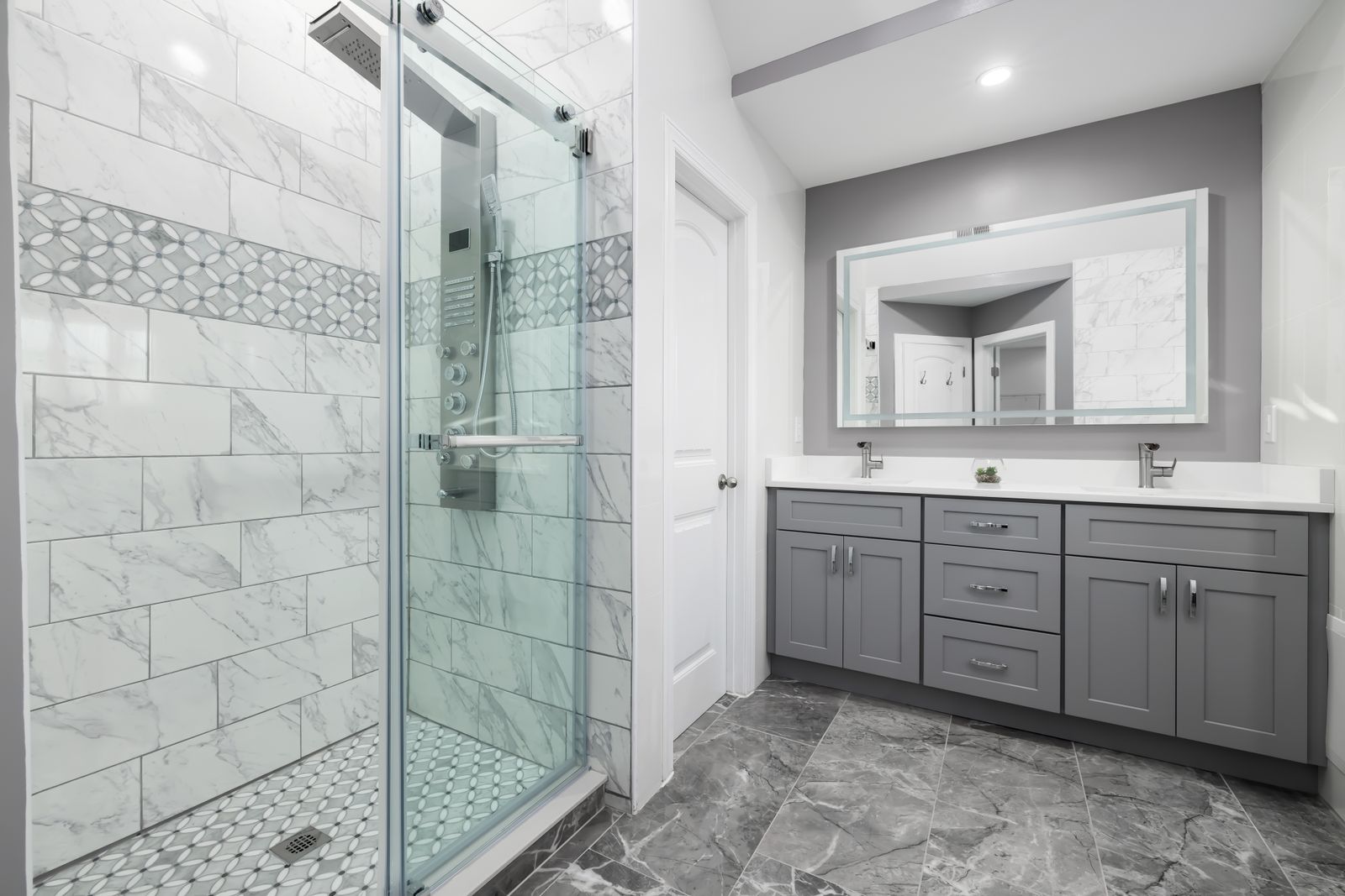 Finished bathroom remodel with a tiled shower and grey vanity