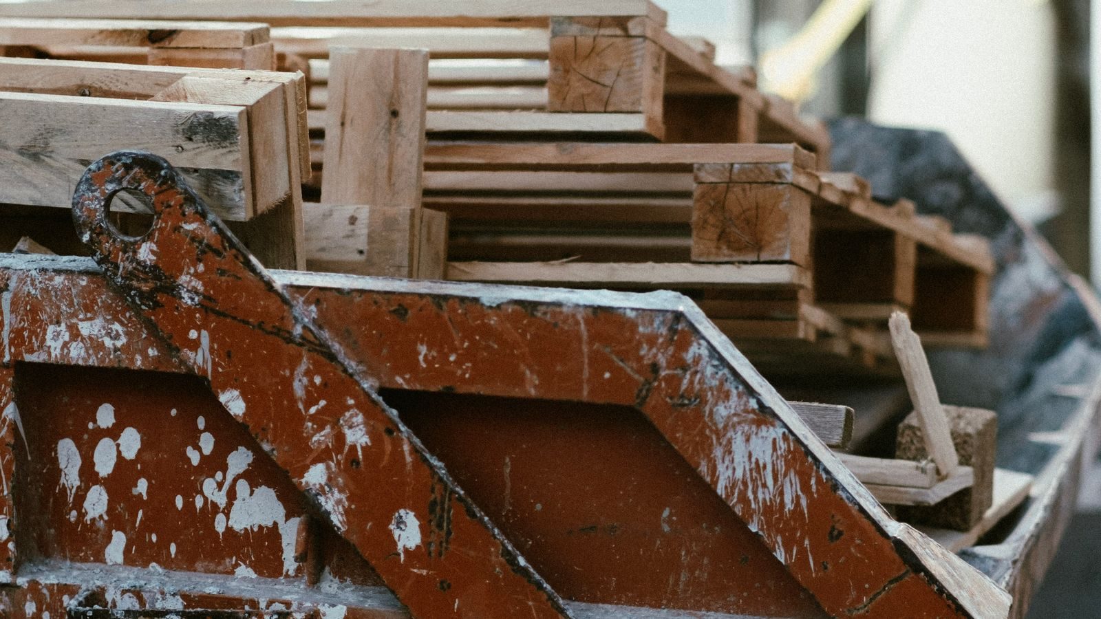 Roll-off container loaded with broken wooden pallets and debris