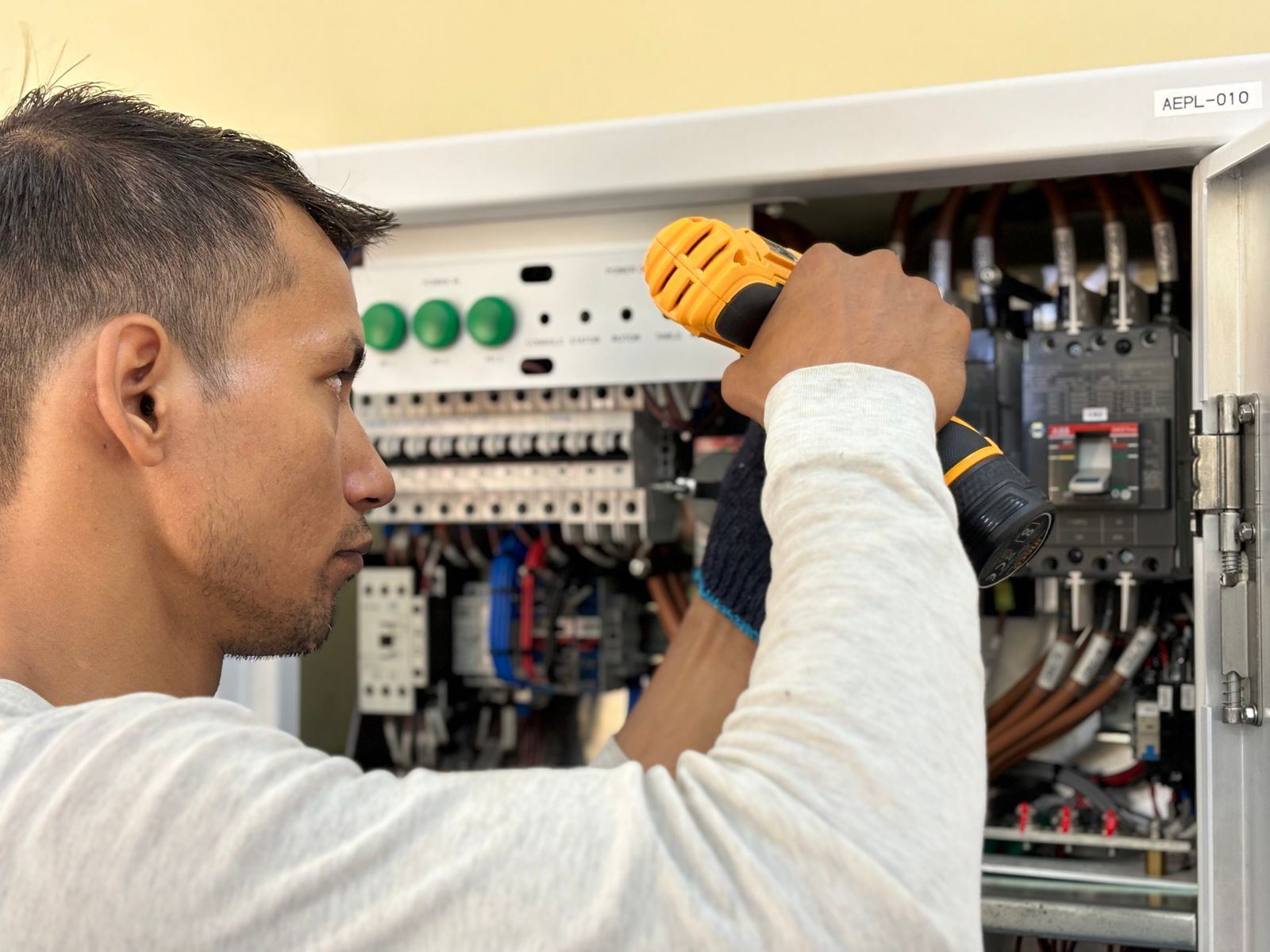 Electrician working inside a circuit breaker panel