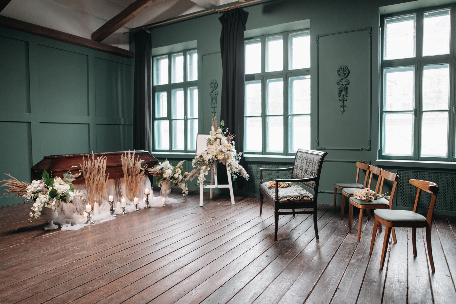 Funeral home chapel room with flowers, candles and chairs set for a service