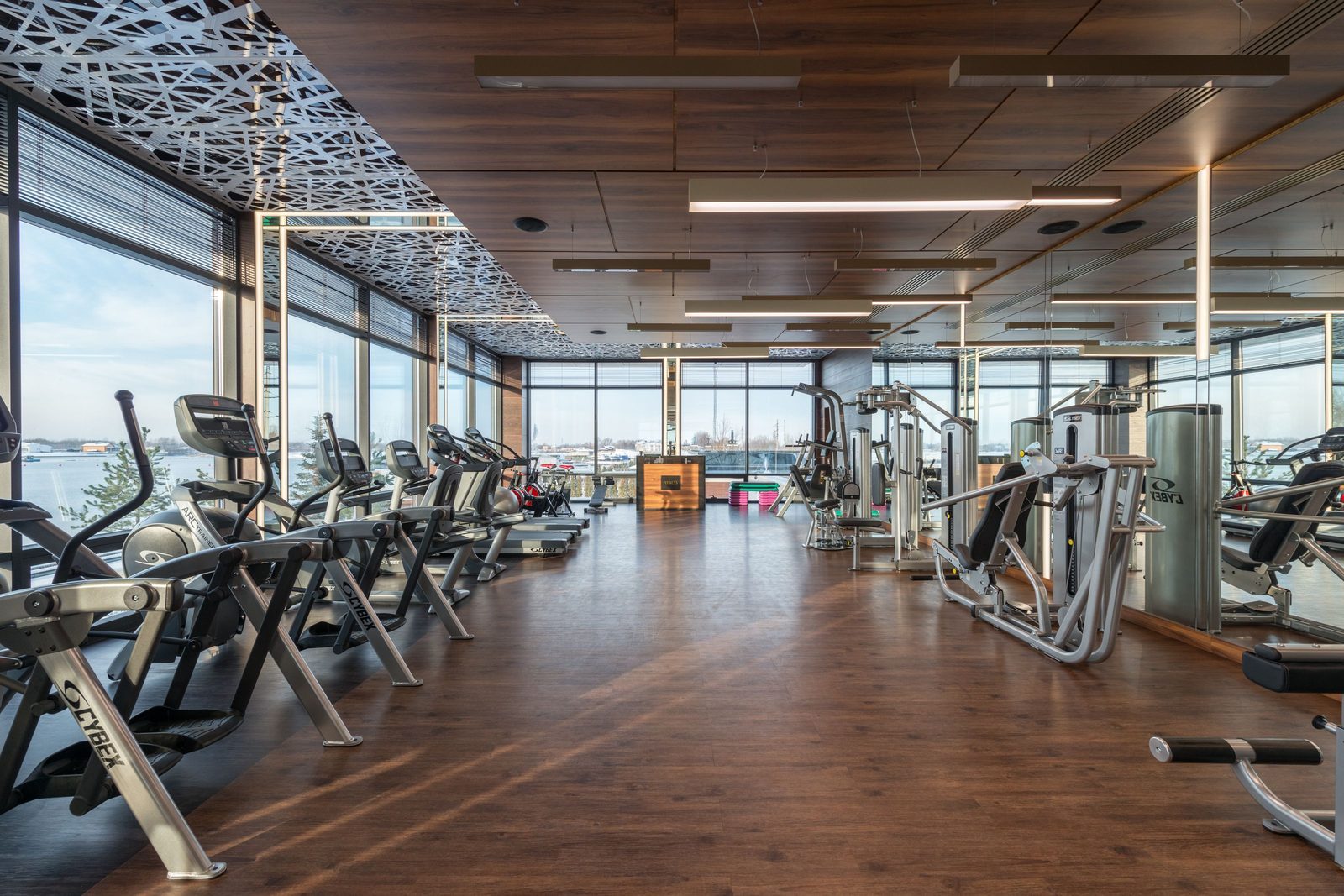 Members training on the floor of a large fitness facility