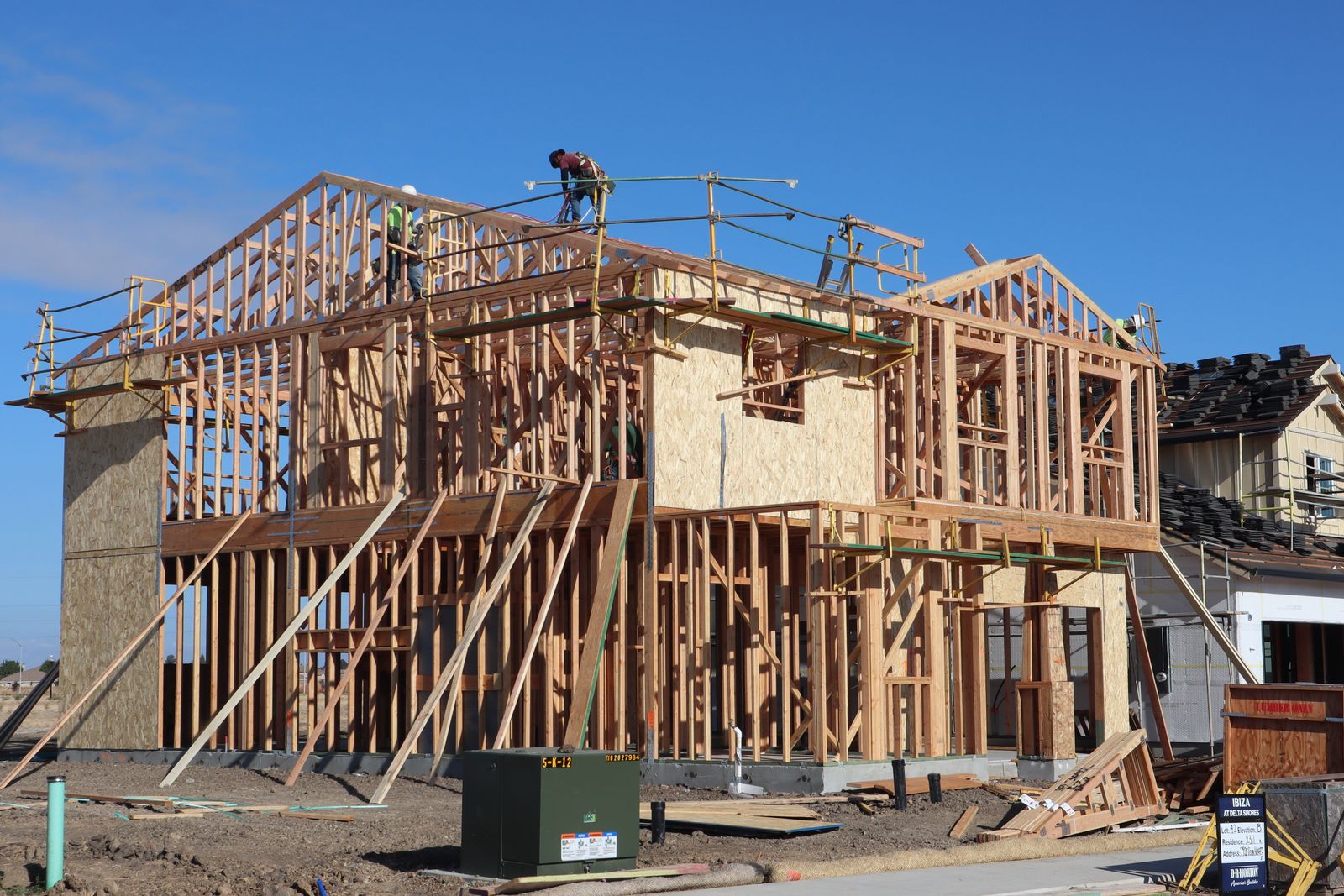 Wood framing of a new house under a clear sky