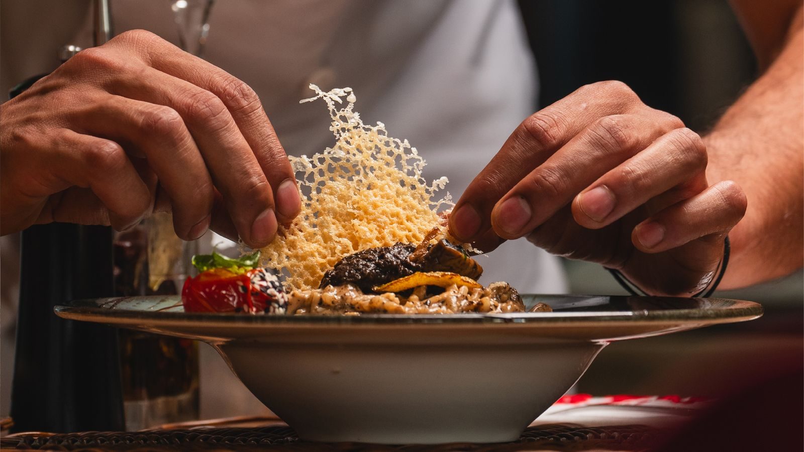 Chef plating dishes at the kitchen pass during service