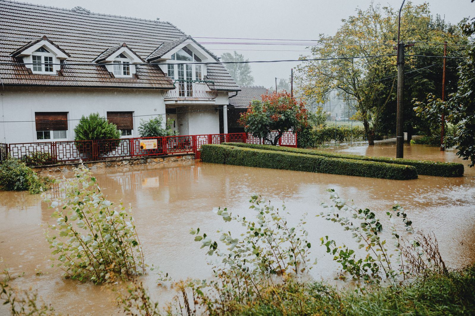 Suburban home surrounded by floodwater after heavy rain