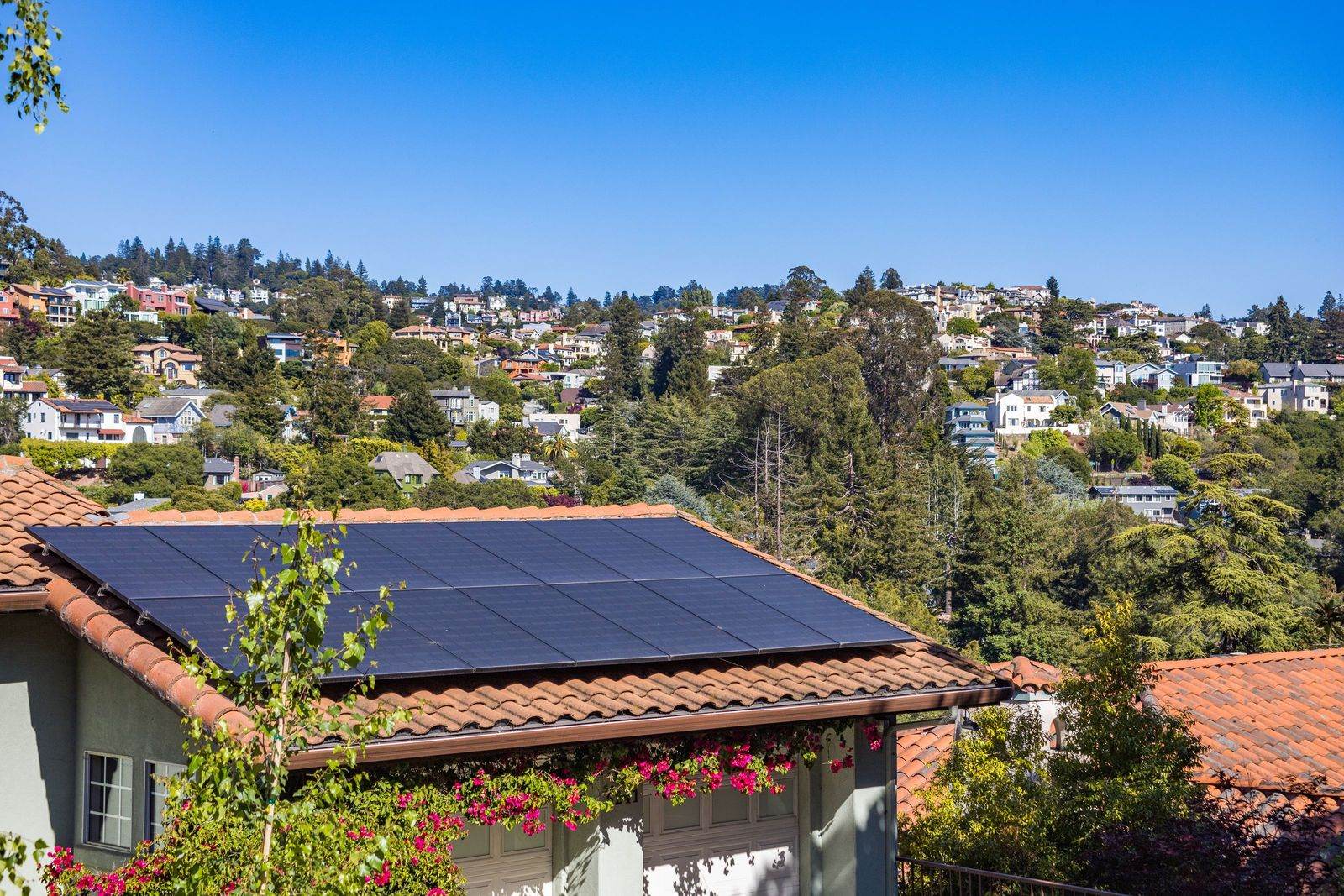 Installer fitting solar panels on a residential roof