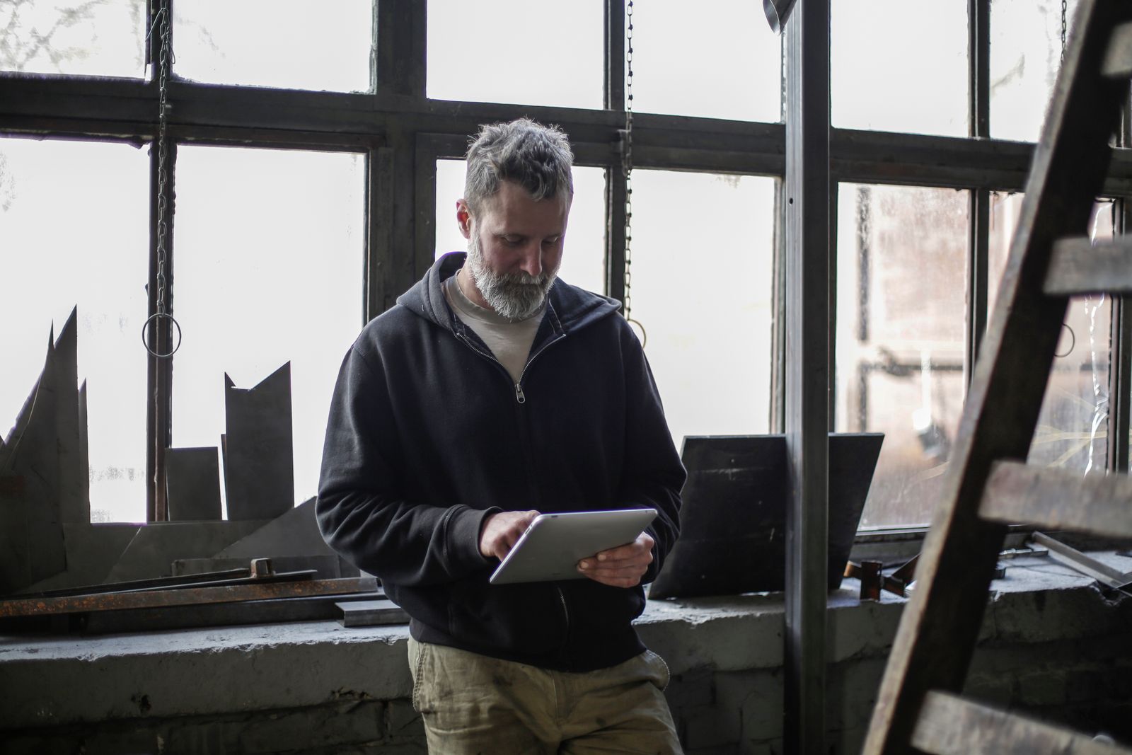 Tradesman on a job site reading his Google Ads account on a tablet
