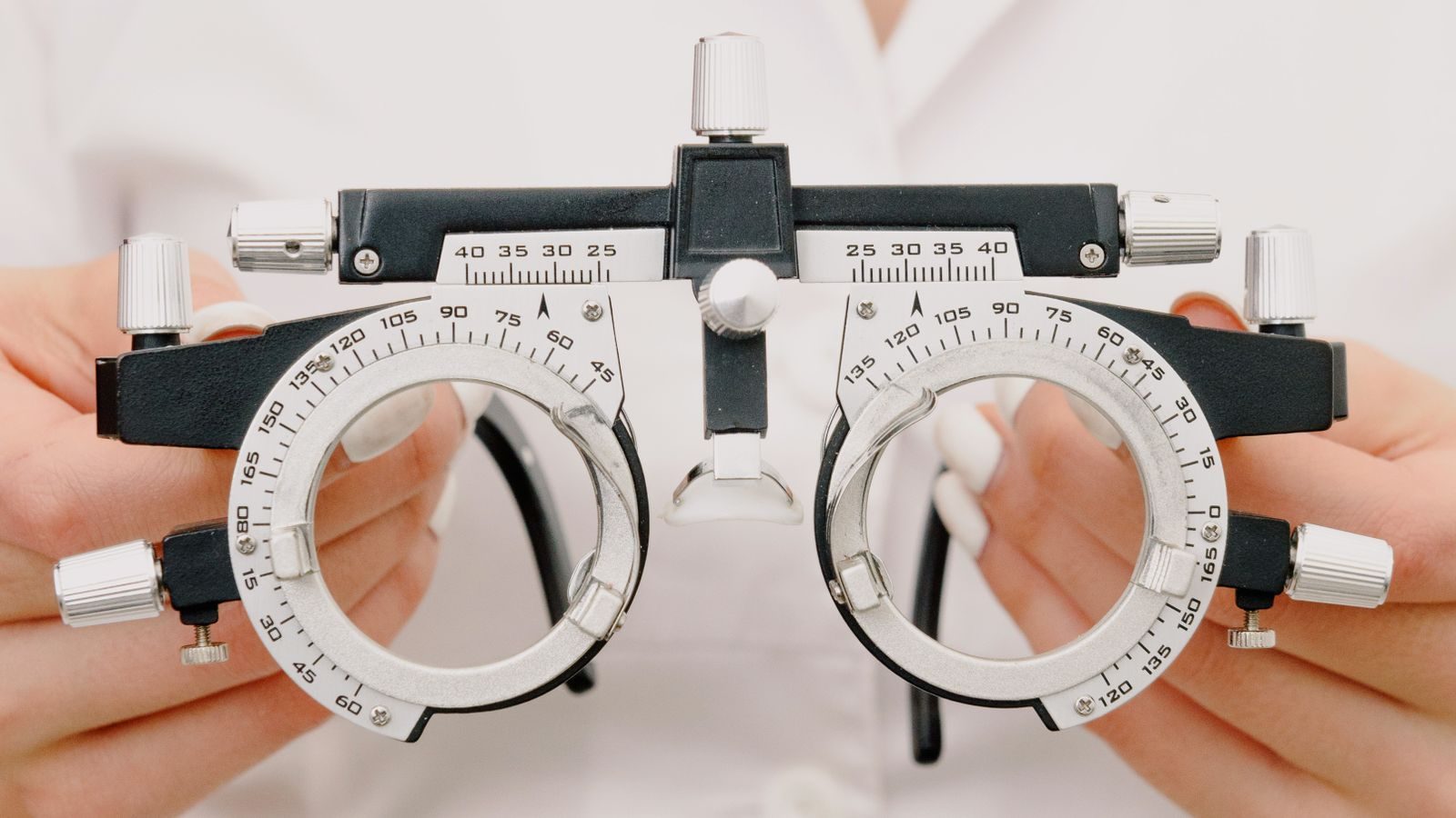 Optometrist holding a trial lens frame used to refine a prescription