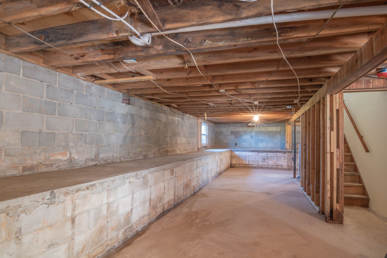 Unfinished basement with concrete block walls