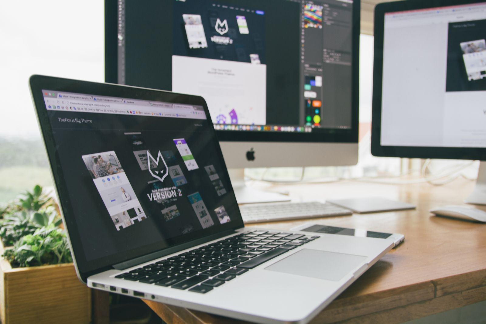Workspace with monitors showing design software